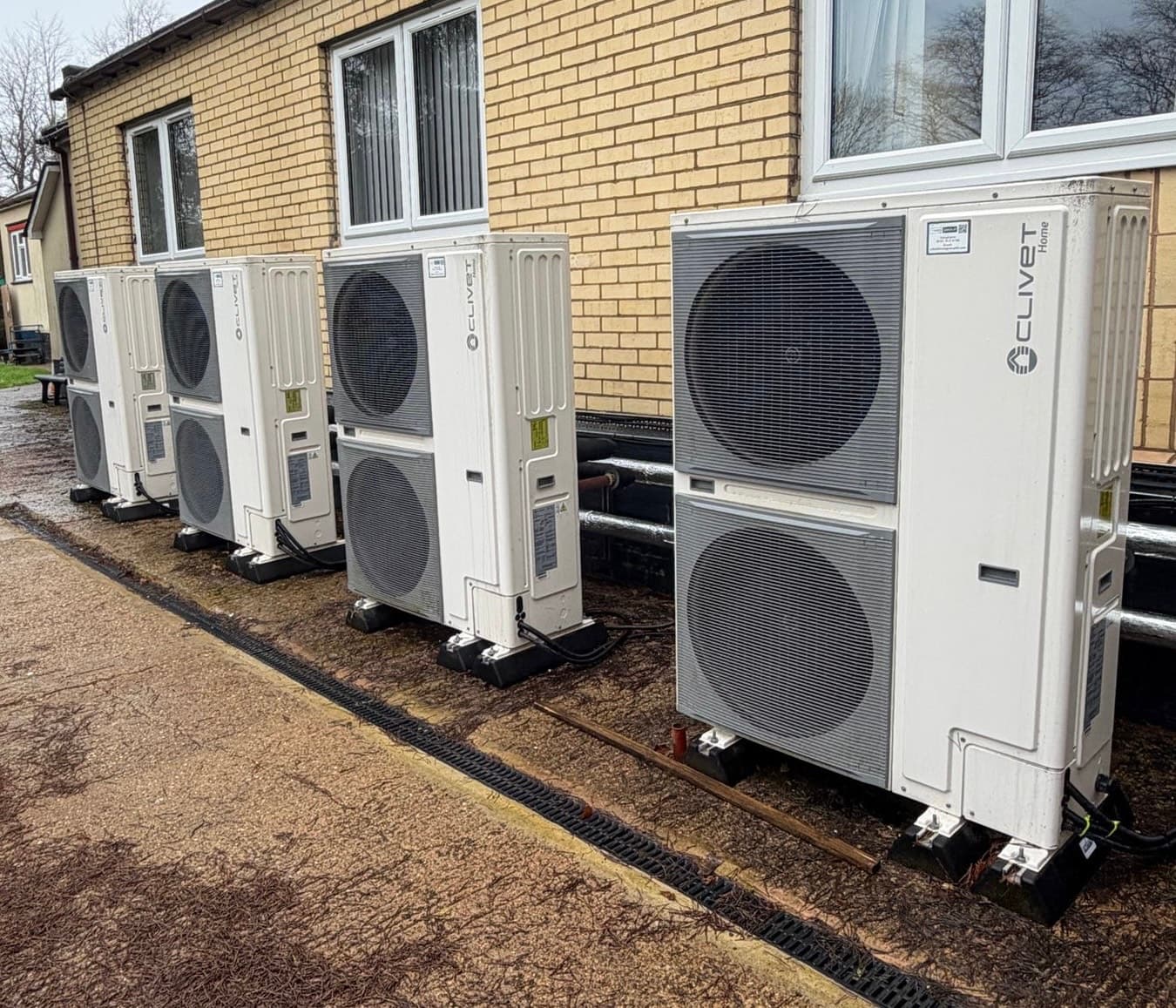 Row of Clivet air source heat pump units installed outside a building